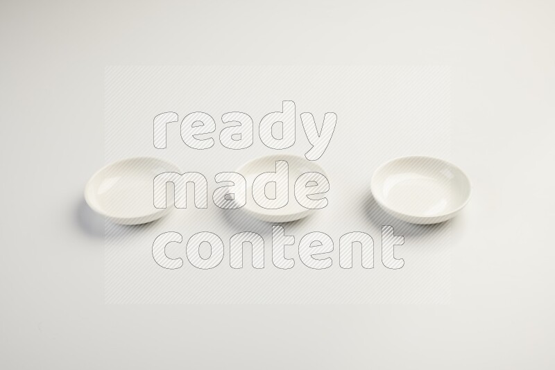 white ceramic round sauce dish on white countertop