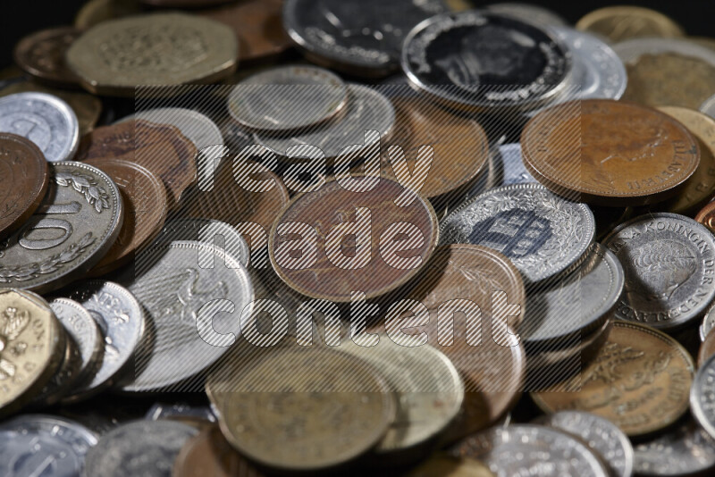 A close-ups of random old coins on black background