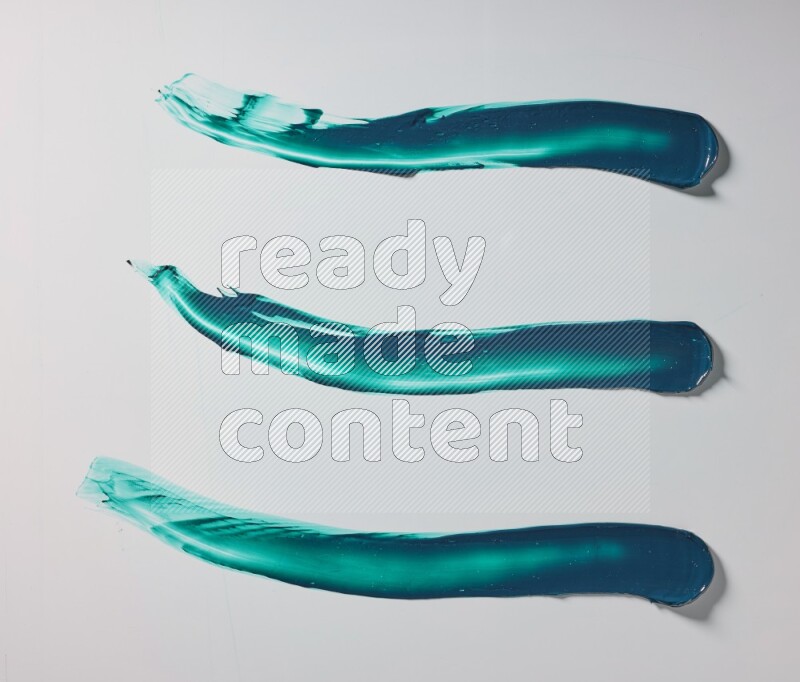 Turquoise painting knife strokes on white background