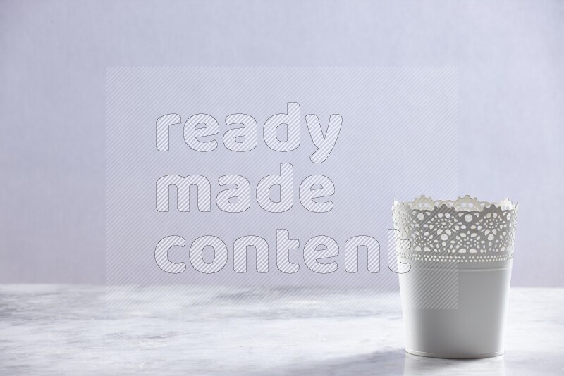 An empty white plant pot on grey marble background
