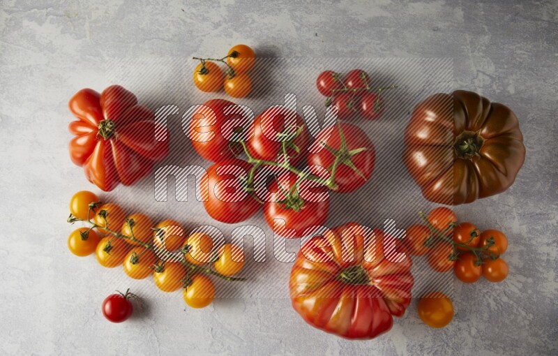 Mixed Tomatoes types topview on a textured vinyl backgrounds