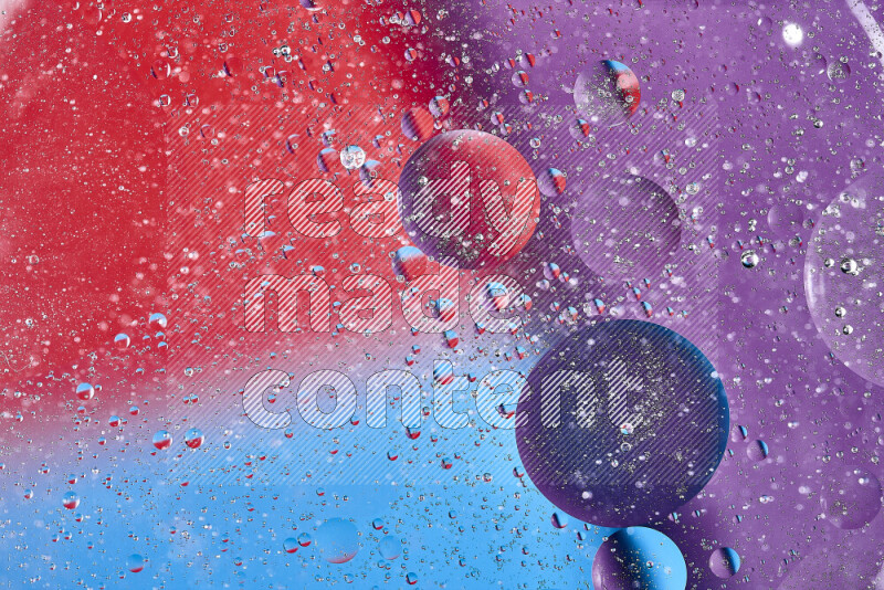 Close-ups of abstract oil bubbles on water surface in shades of blue, red and purple