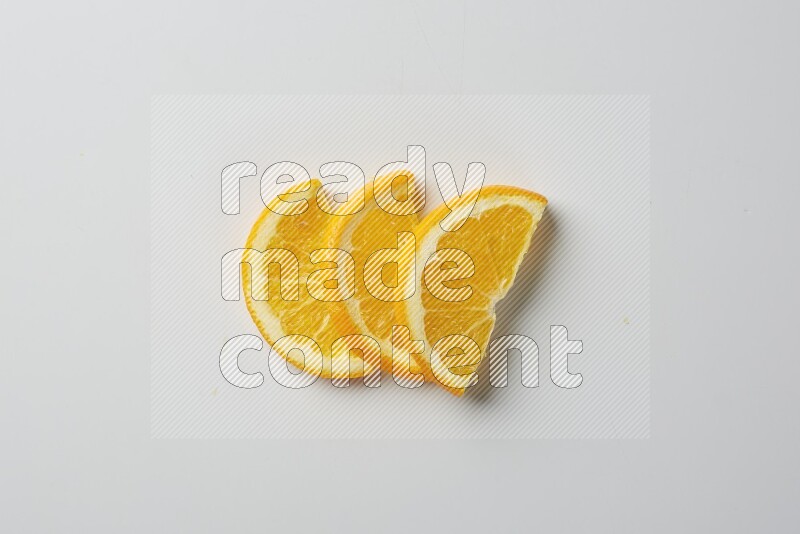 Three halves of an orange slices on white background