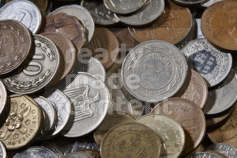 A close-ups of random old coins on black background