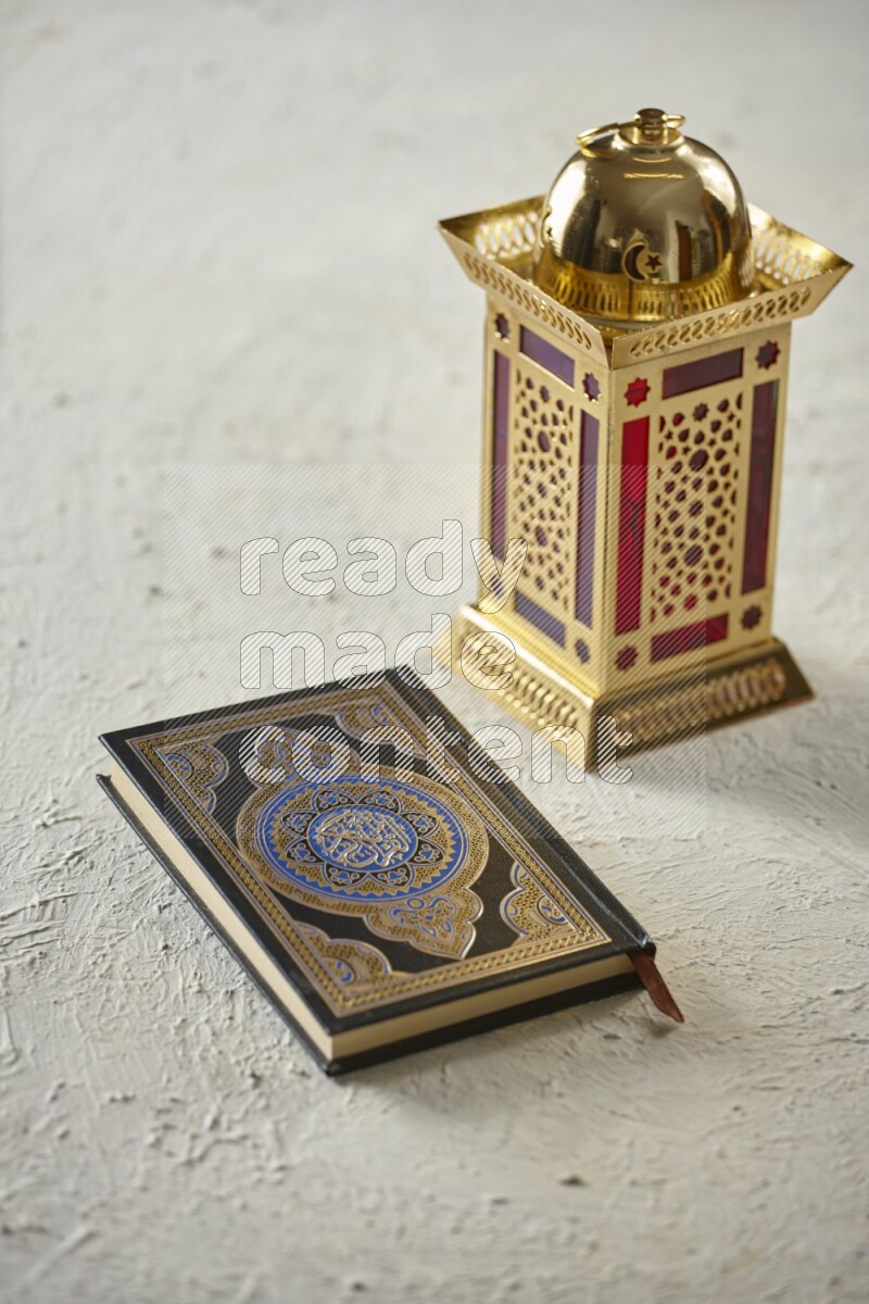 A golden lantern with different drinks, dates, nuts, prayer beads and quran on textured white background