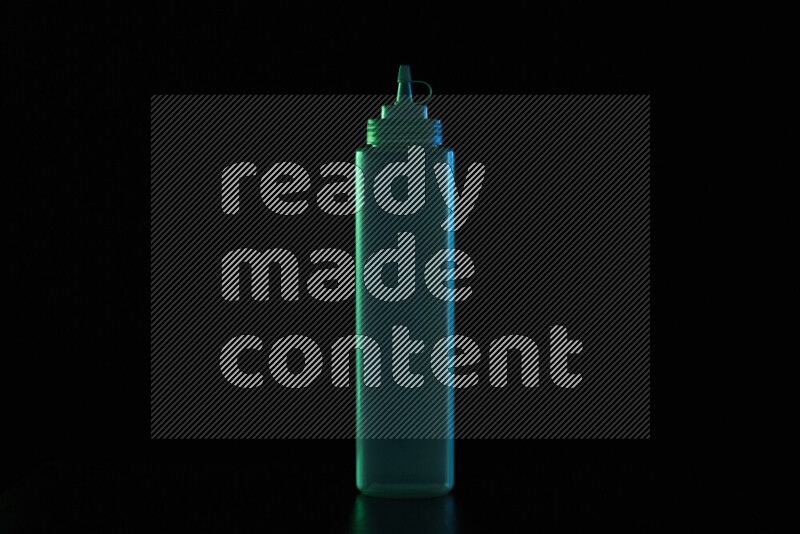 A squeeze bottle with colored rim light against black background