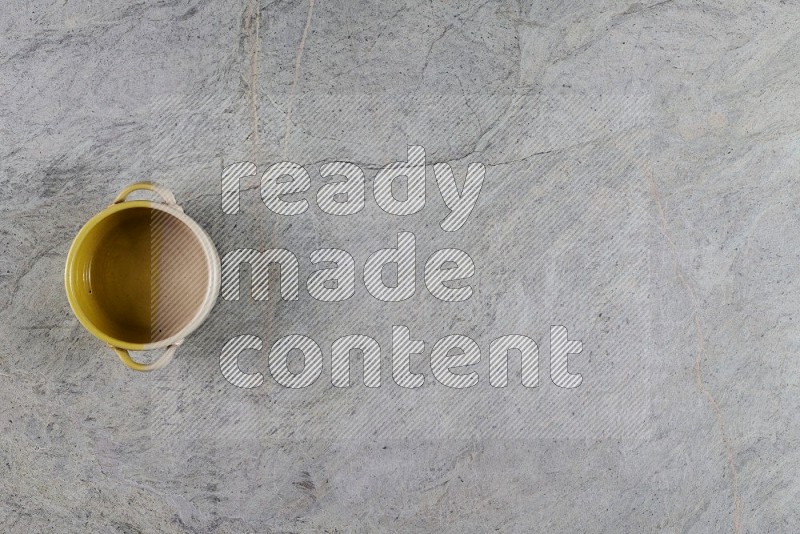 Top View Shot Of A Multicolored Pottery Bowl On Grey Marble Flooring