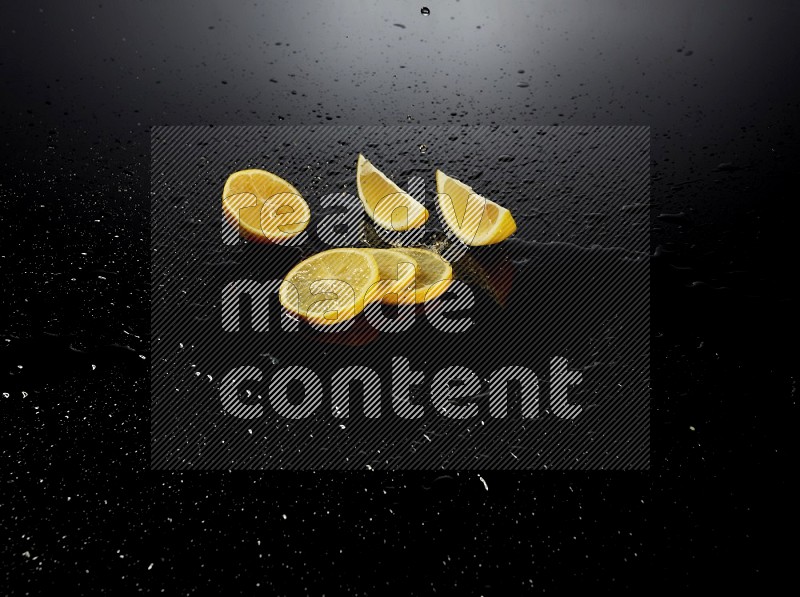 Lemon slices with water drops, and droplets on black background