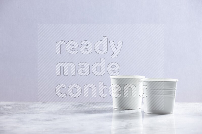 An empty white plant pot on grey marble background