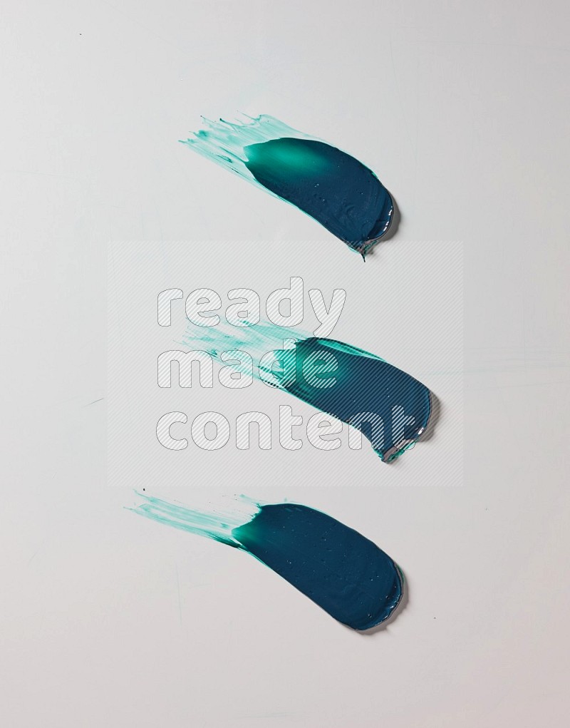 Turquoise painting knife strokes on white background