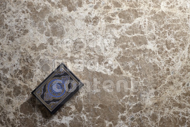 Quran on beige marble background