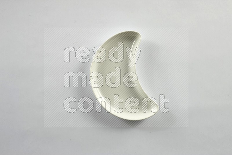 A pottery crescent plate on white background
