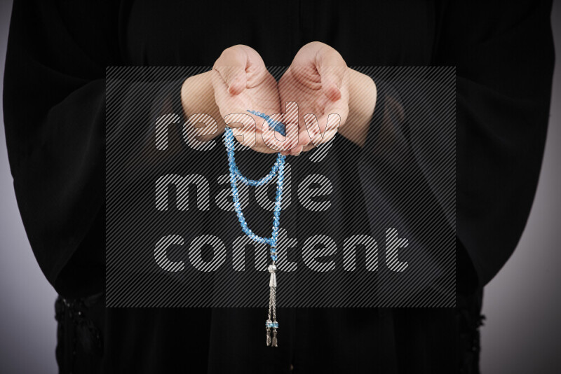 Woman hands holding praying beads (sebha) in different positions