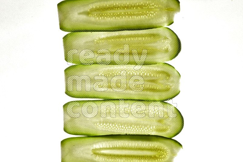 Zucchini slices on illuminated white background
