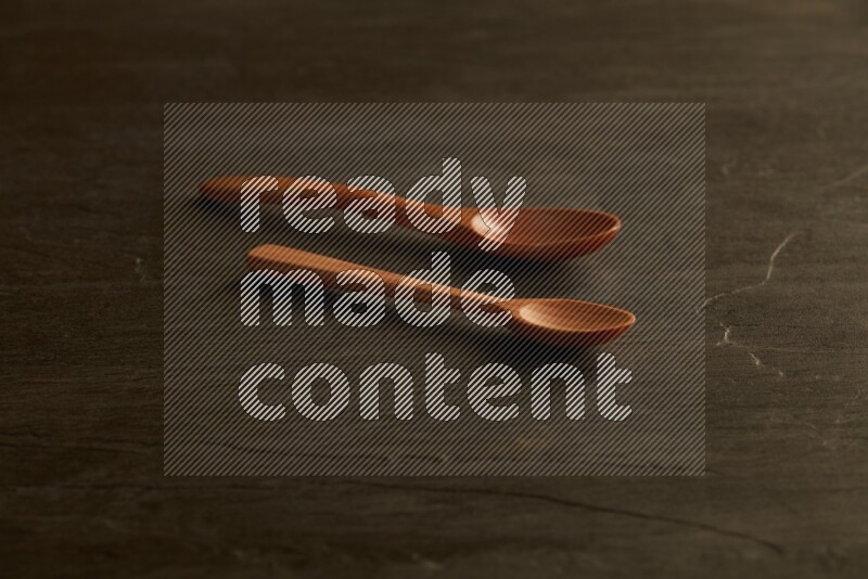 wooden spoon on black slate background