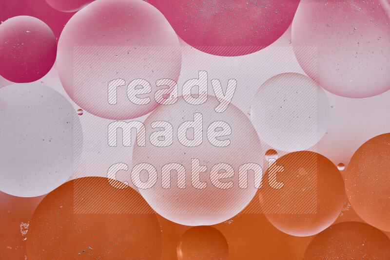Close-ups of abstract oil bubbles on water surface in shades of white, orange and pink