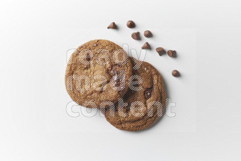 Chocolate chips cookies with chocolate beside it on a white background