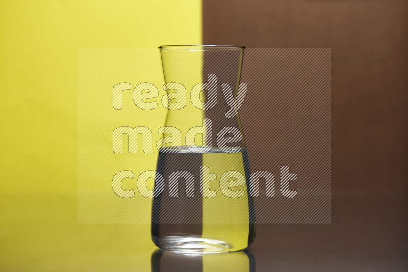 The image features a clear glassware filled with water, set against yellow and brown background