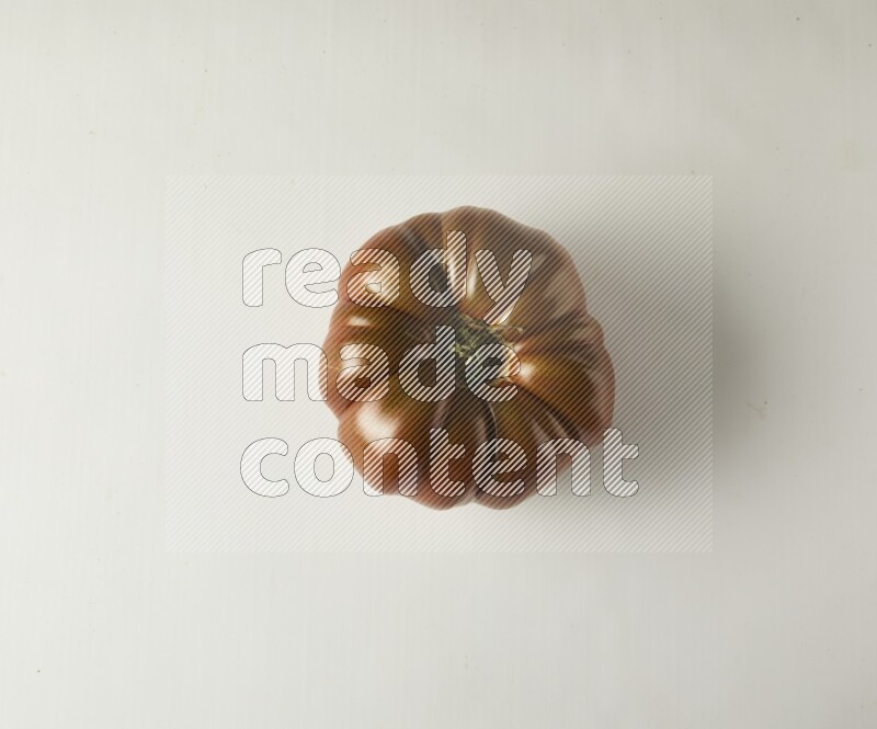 Single topview Heirloom tomato on a white backgrounds