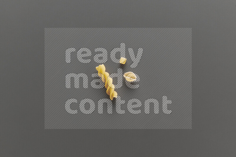 Different pasta types on grey background