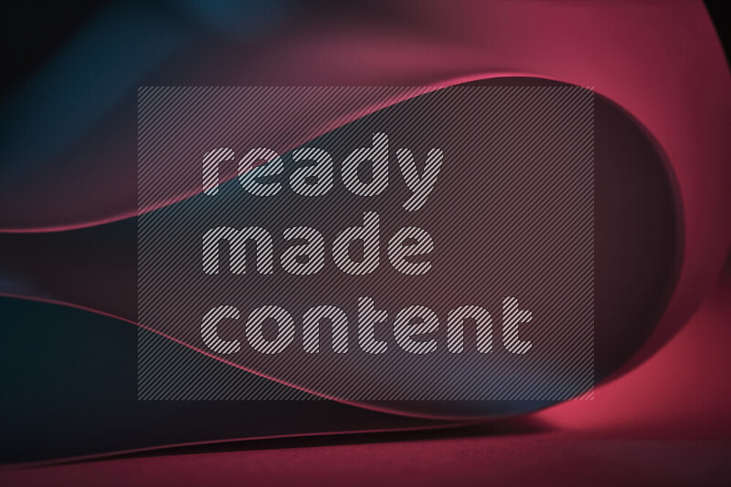 فن تجريدي يعرض منحنيات وتدرجات اللون الأزرق والأحمر مكونه بضوء ملون