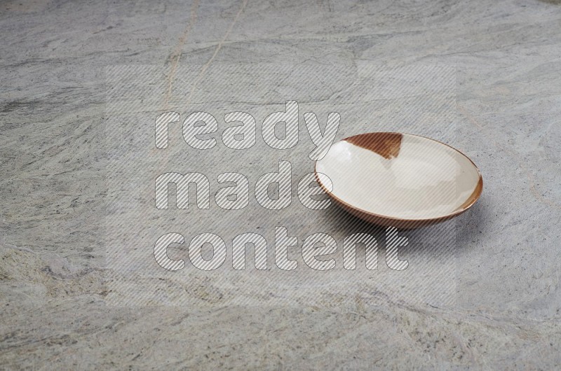 Multicolored Pottery Plate On Grey Marble Flooring