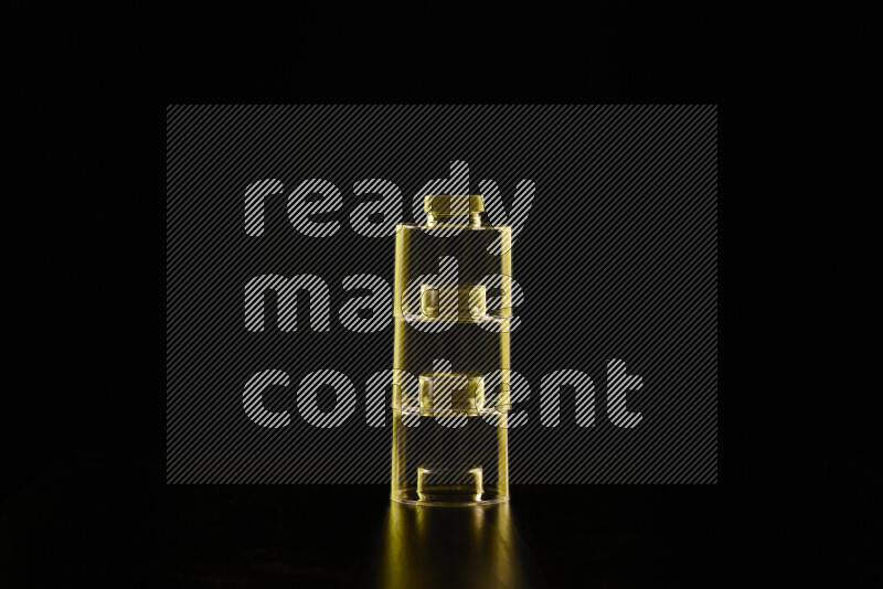 Glassware with rim light in yellow against black background