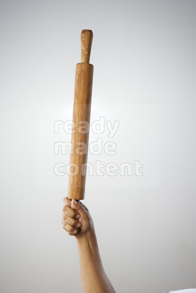 Male Hand Holding Rolling Pin on white background