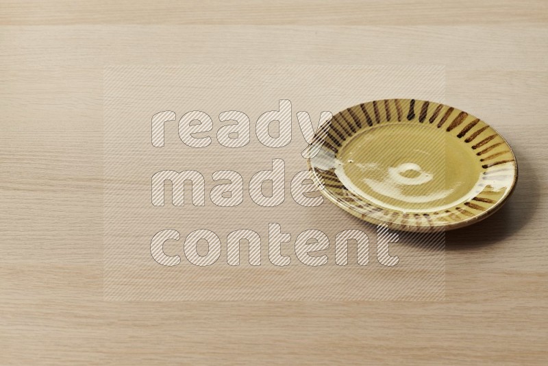 Multicolored Pottery Plate on Oak Wooden Flooring, 45 degrees