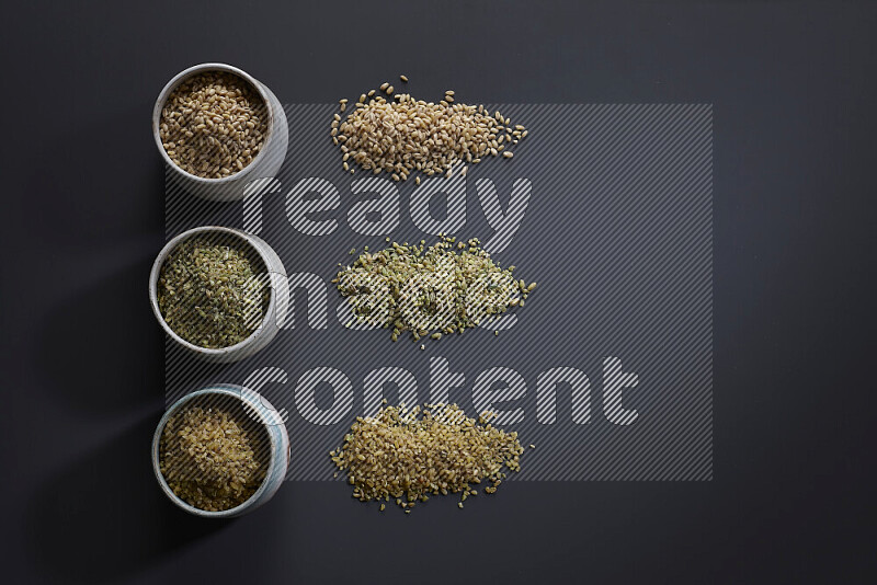 Legumes in pottery bowls on grey background