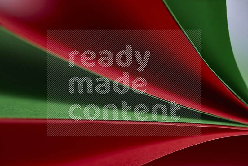 An abstract art showing red and green paper sheets arranged in an overlapping curves
