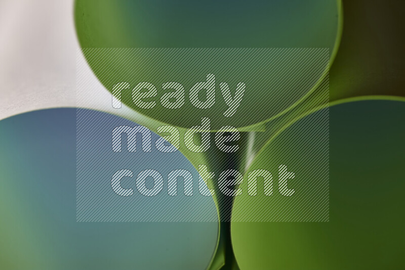 The image shows an abstract paper art with circular shapes in varying shades of green
