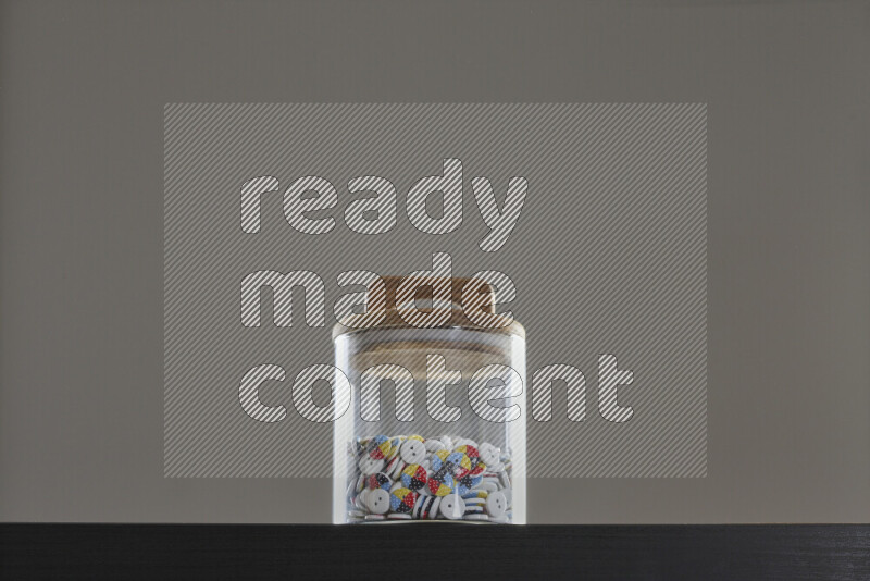 Buttons in a glass jar on black background