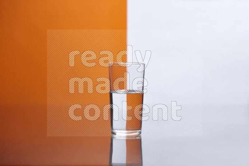 The image features a clear glassware filled with water, set against white and orange background