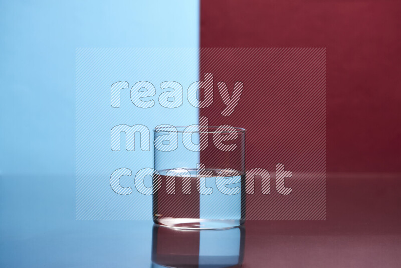 The image features a clear glassware filled with water, set against light blue and dark red background