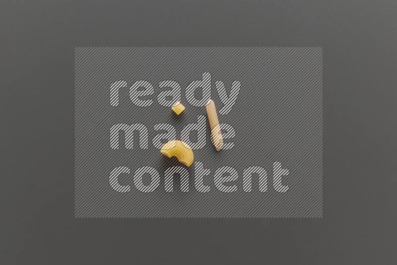 Different pasta types on grey background