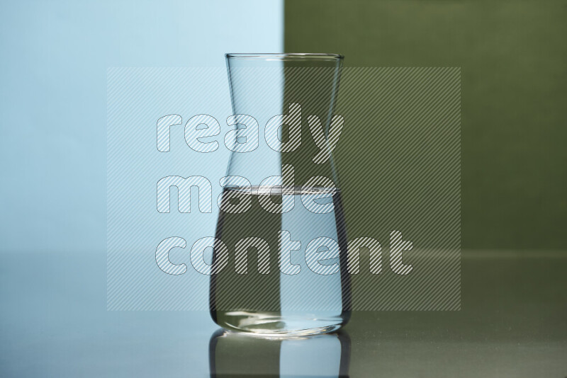 The image features a clear glassware filled with water, set against light blue and dark green background