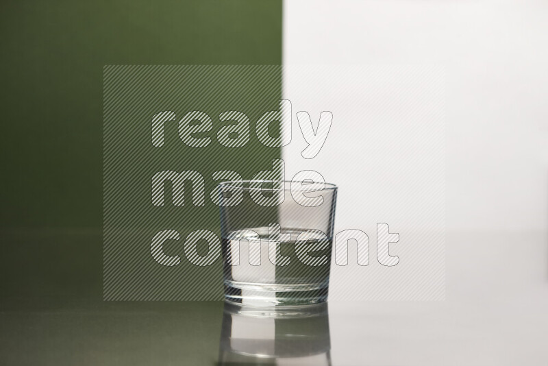 The image features a clear glassware filled with water, set against white and dark green background