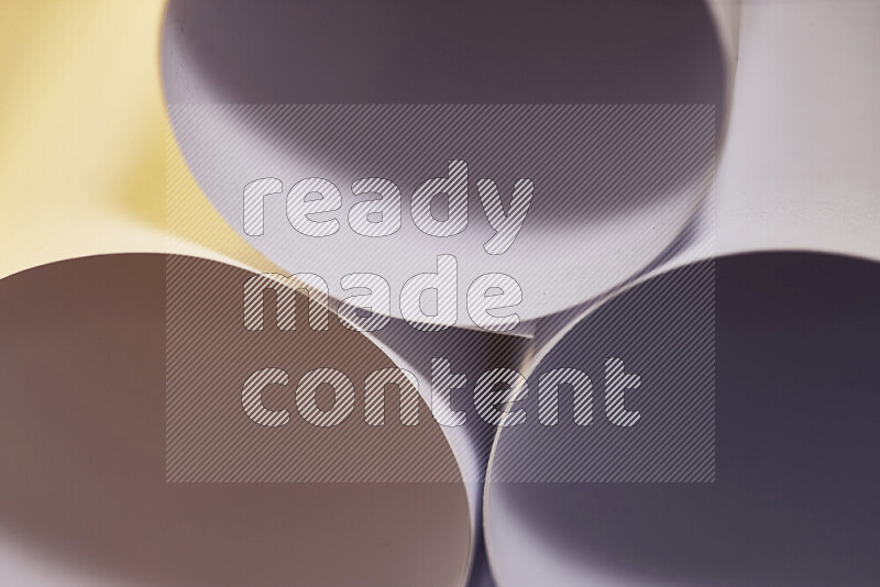 The image shows an abstract paper art with circular shapes in varying shades of grey and warm tones