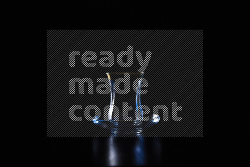 Glassware with rim light in red and white against black background