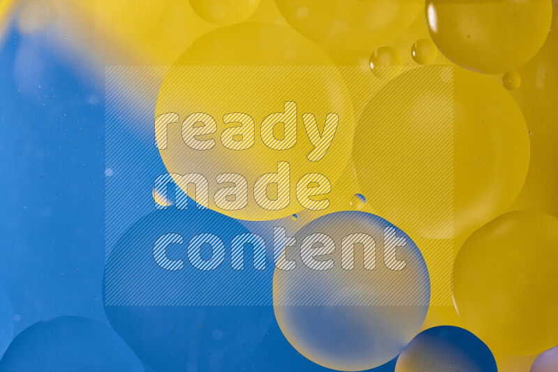 Close-ups of abstract oil bubbles on water surface in shades of blue and yellow