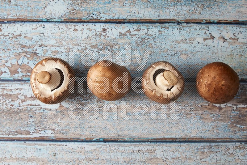 small fresh Cremini mushrooms topview on wooden blue background