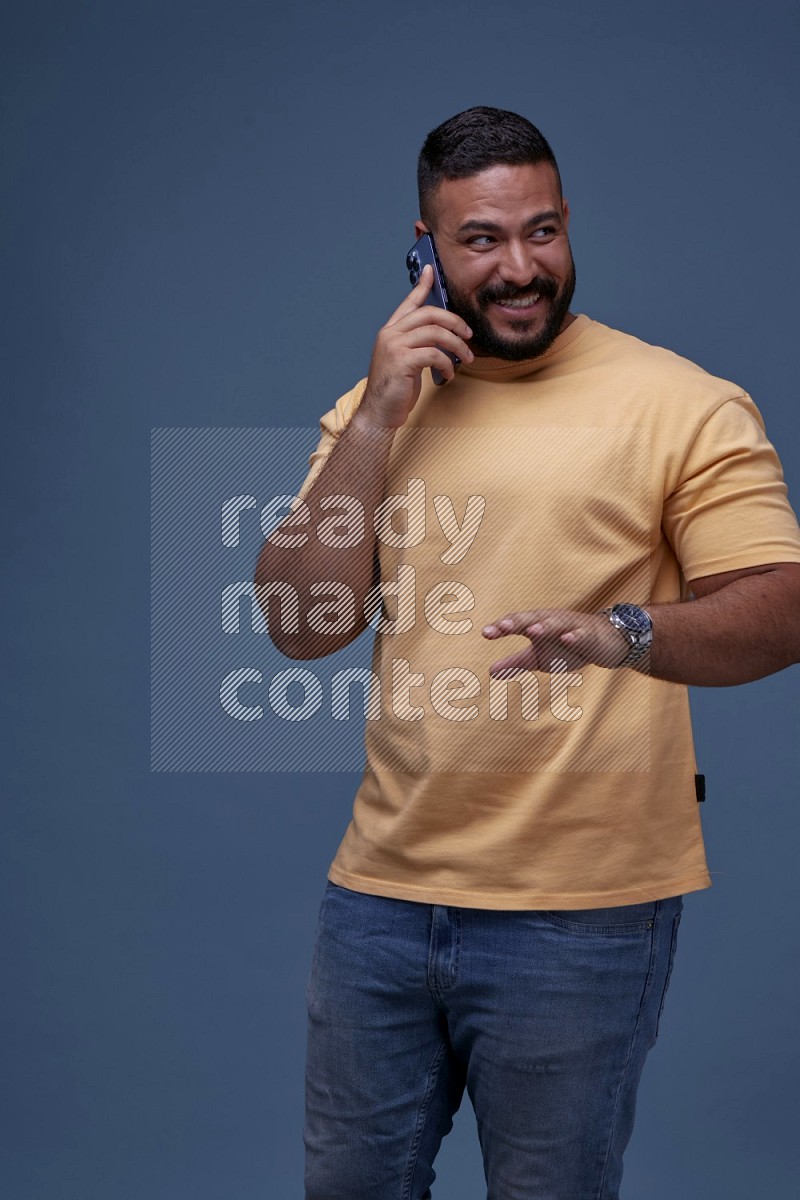 A man Calling on Blue Background wearing Orange T-shirt