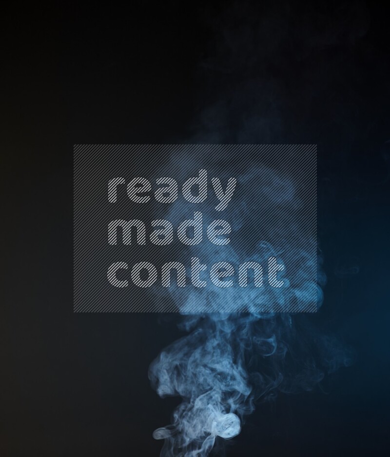 Heavy smoke in blue isolated on black background