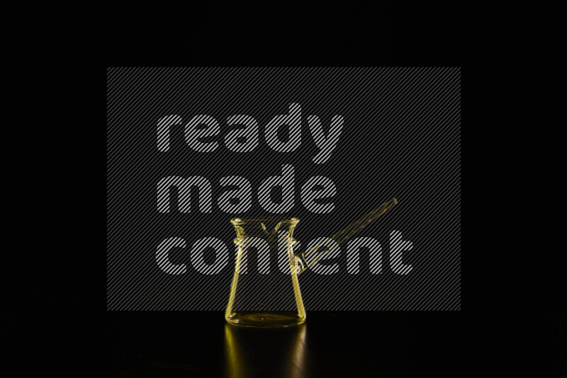 Glassware with rim light in yellow against black background