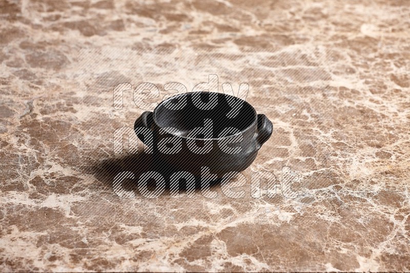 Black Pottery Bowl on Beige Marble Flooring, 45 degrees