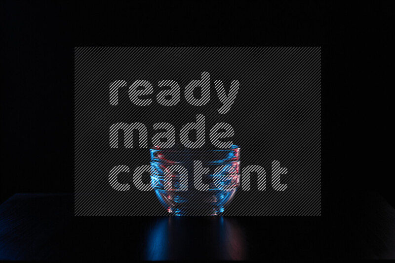 Glassware with rim light in red and blue against black background