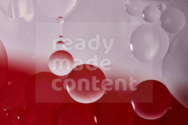 Close-ups of abstract oil bubbles on water surface in shades of white and red