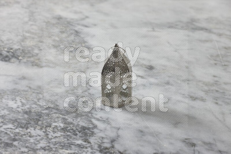 A lantern placed on a grey marble background