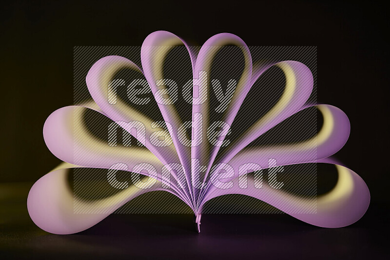 An abstract art piece displaying smooth curves in yellow and pink gradients created by colored light